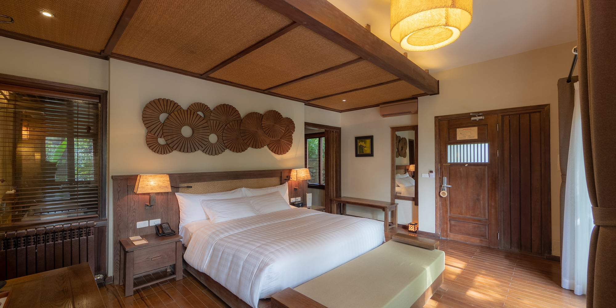 a bedroom with a bed and a lamp