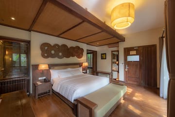 a bedroom with a bed and a lamp