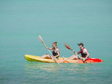a man and woman in kayaks on the water