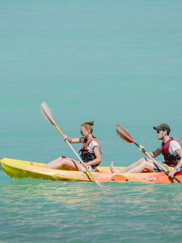 a man and woman in kayaks on the water