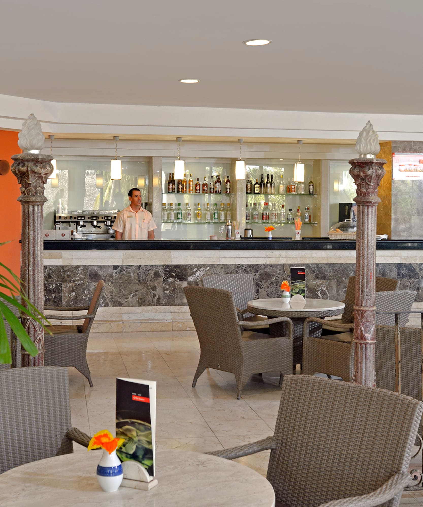 a man standing behind a bar