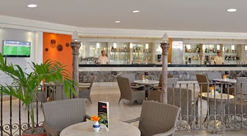 a man standing behind a bar