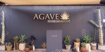 a sign with plants in pots