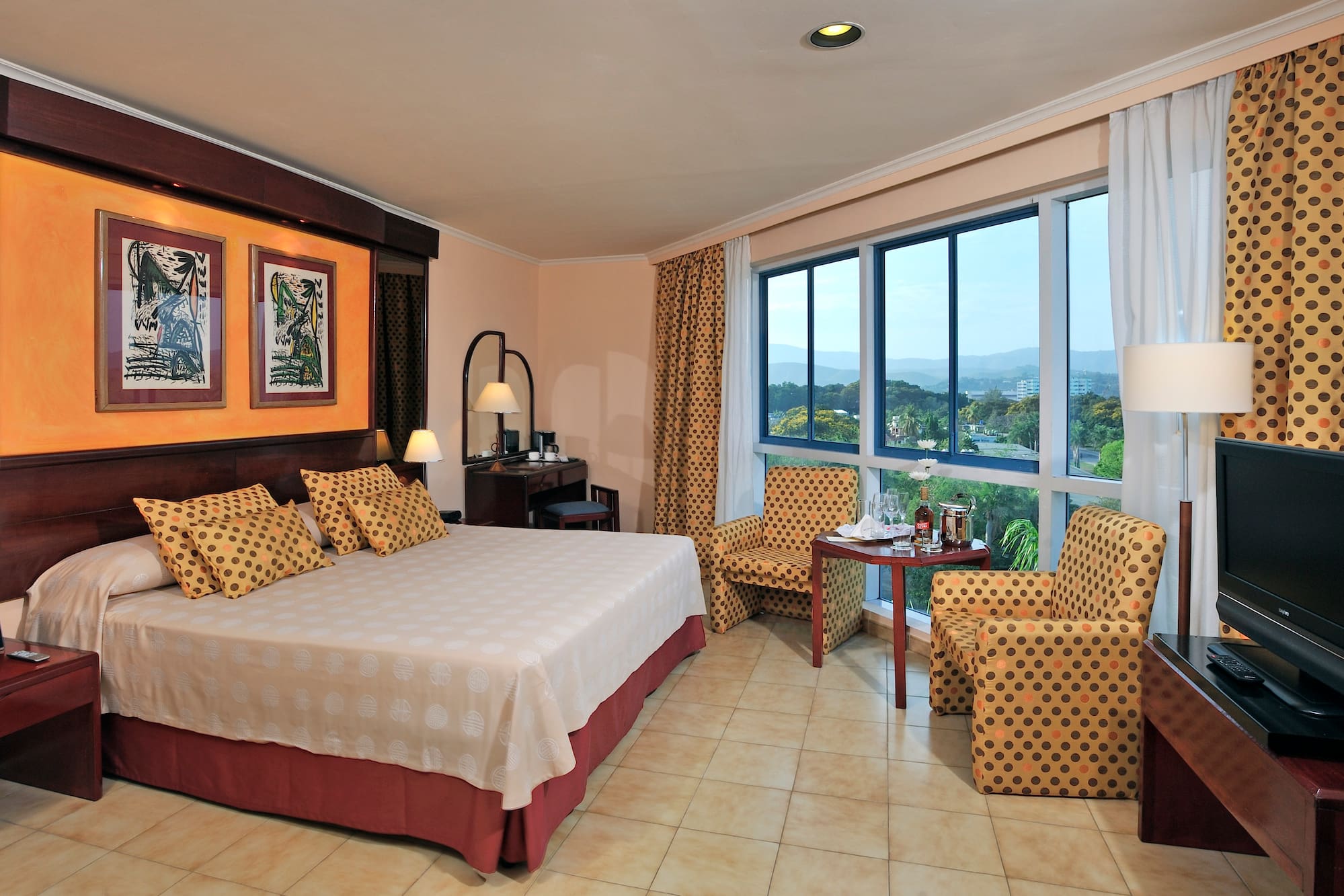 a room with a bed and chairs