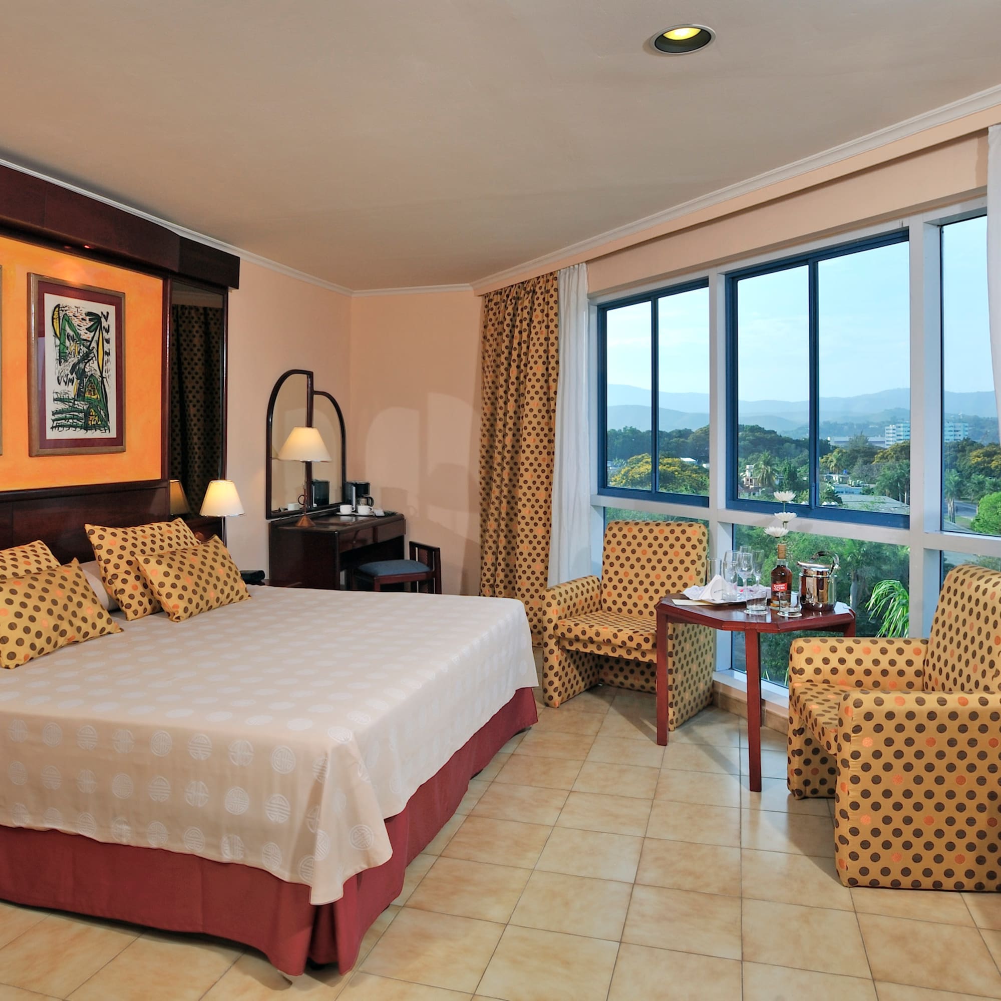 a room with a bed and chairs