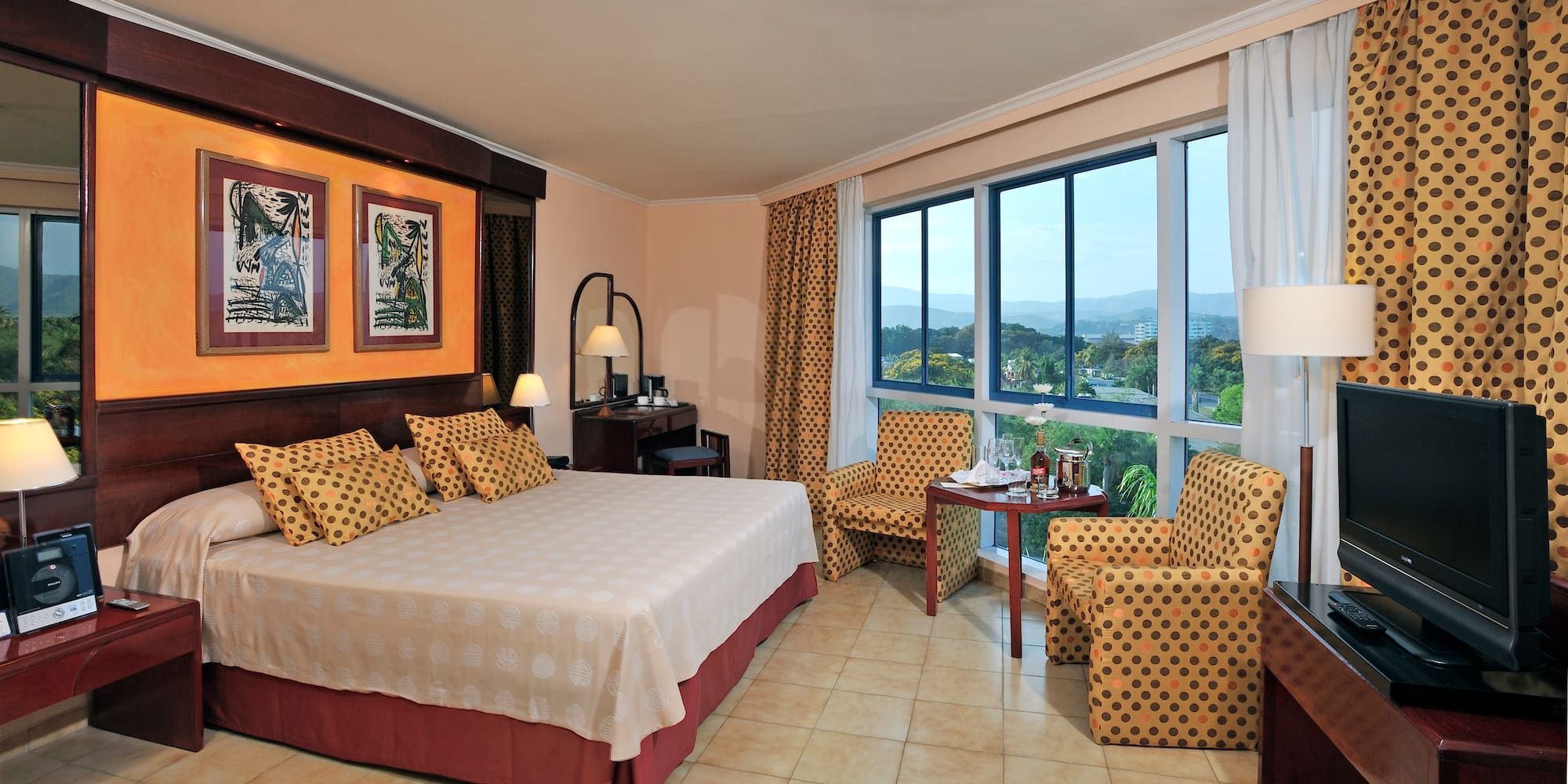 a room with a bed and chairs