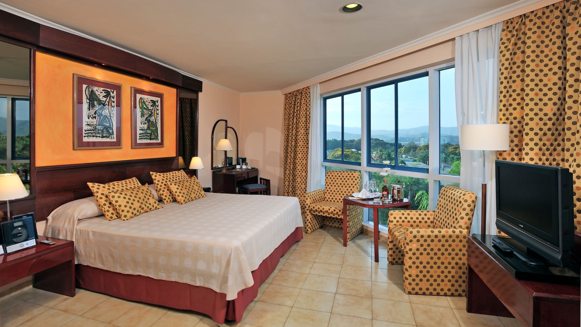 a room with a bed and chairs