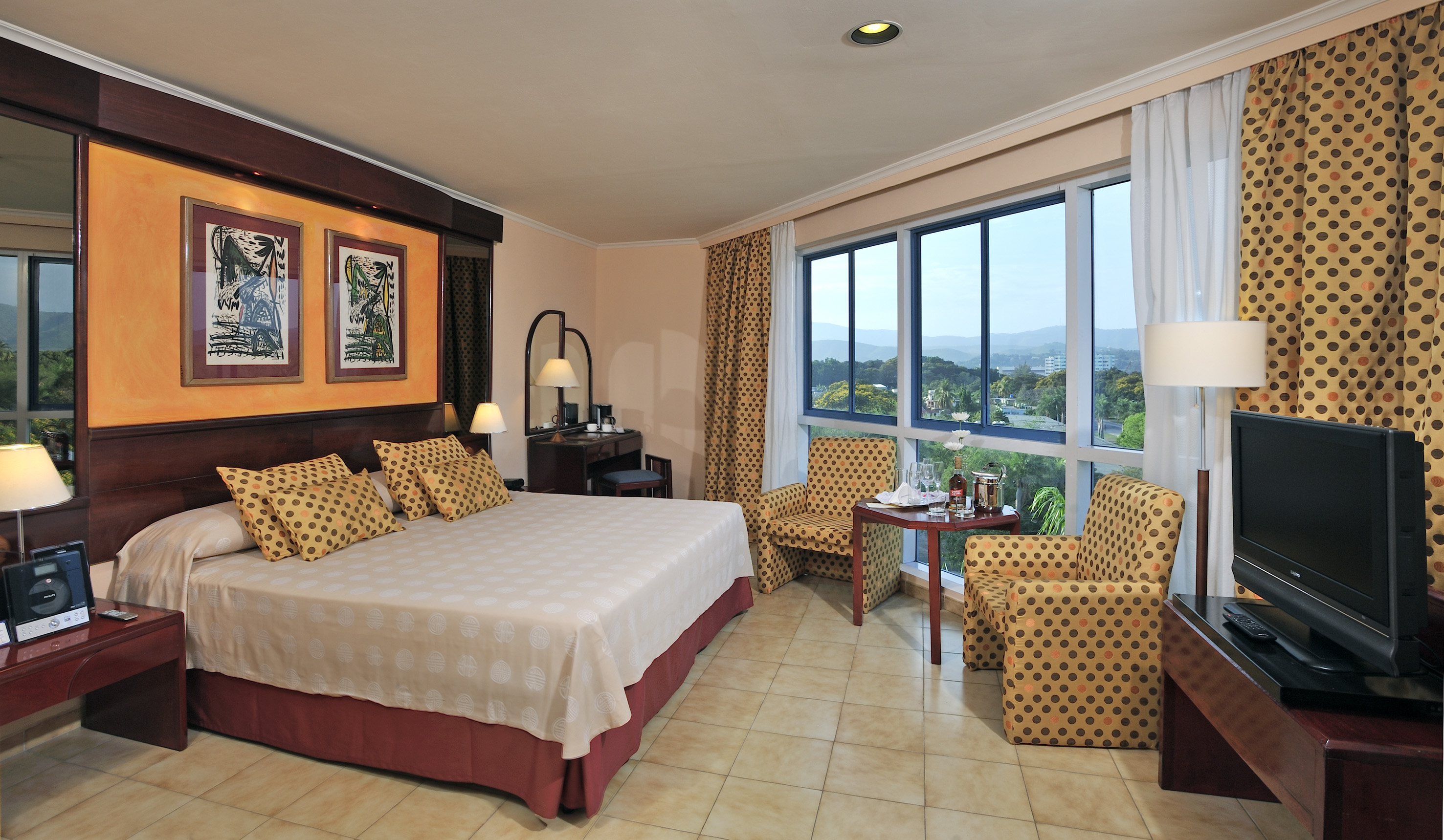 a room with a bed and chairs