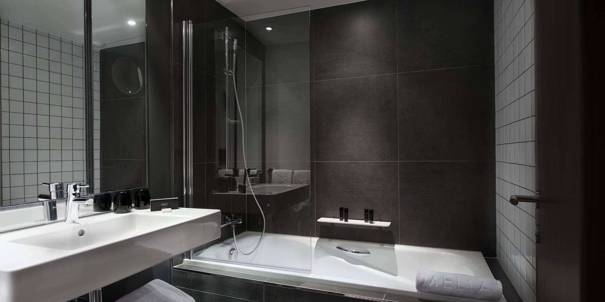 a bathroom with a glass shower and a bathtub