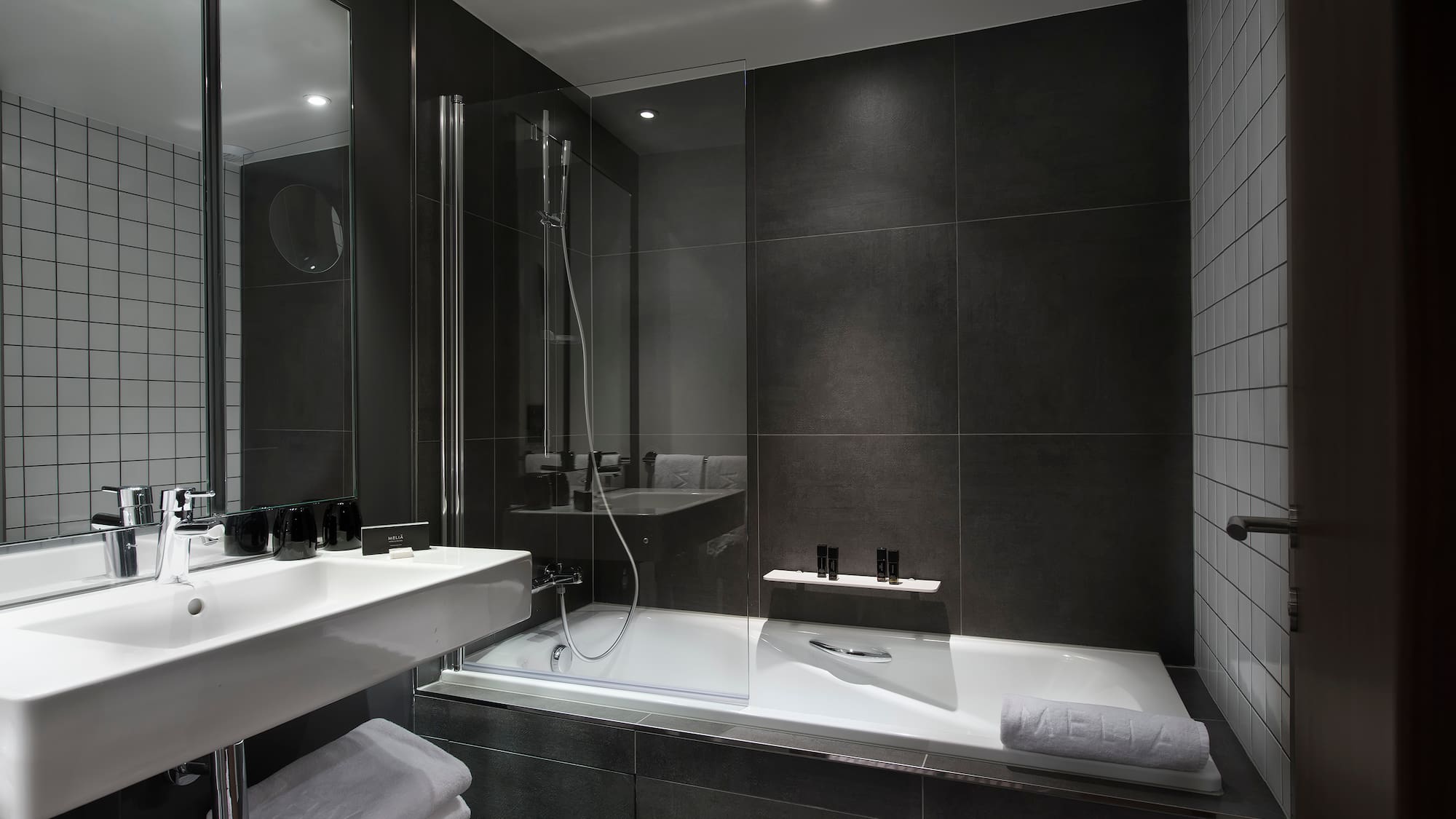 a bathroom with a glass shower and a bathtub