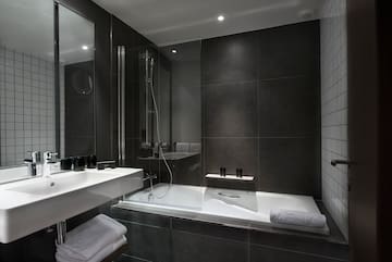 a bathroom with a glass shower and a bathtub