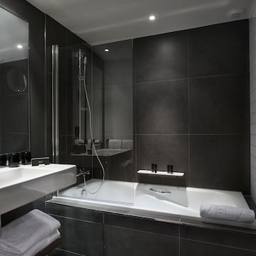 a bathroom with a glass shower and a bathtub