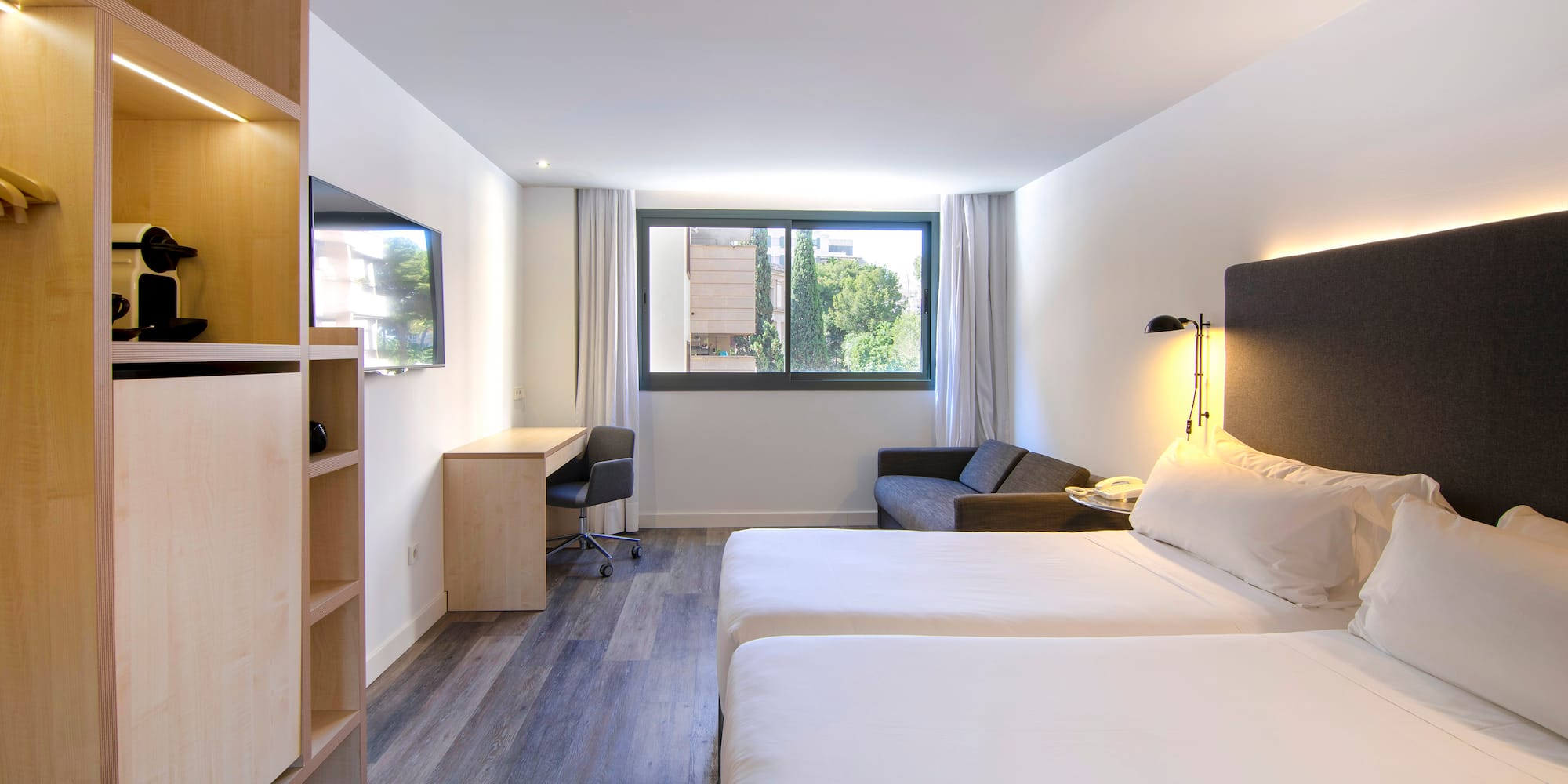 a room with two beds and a desk