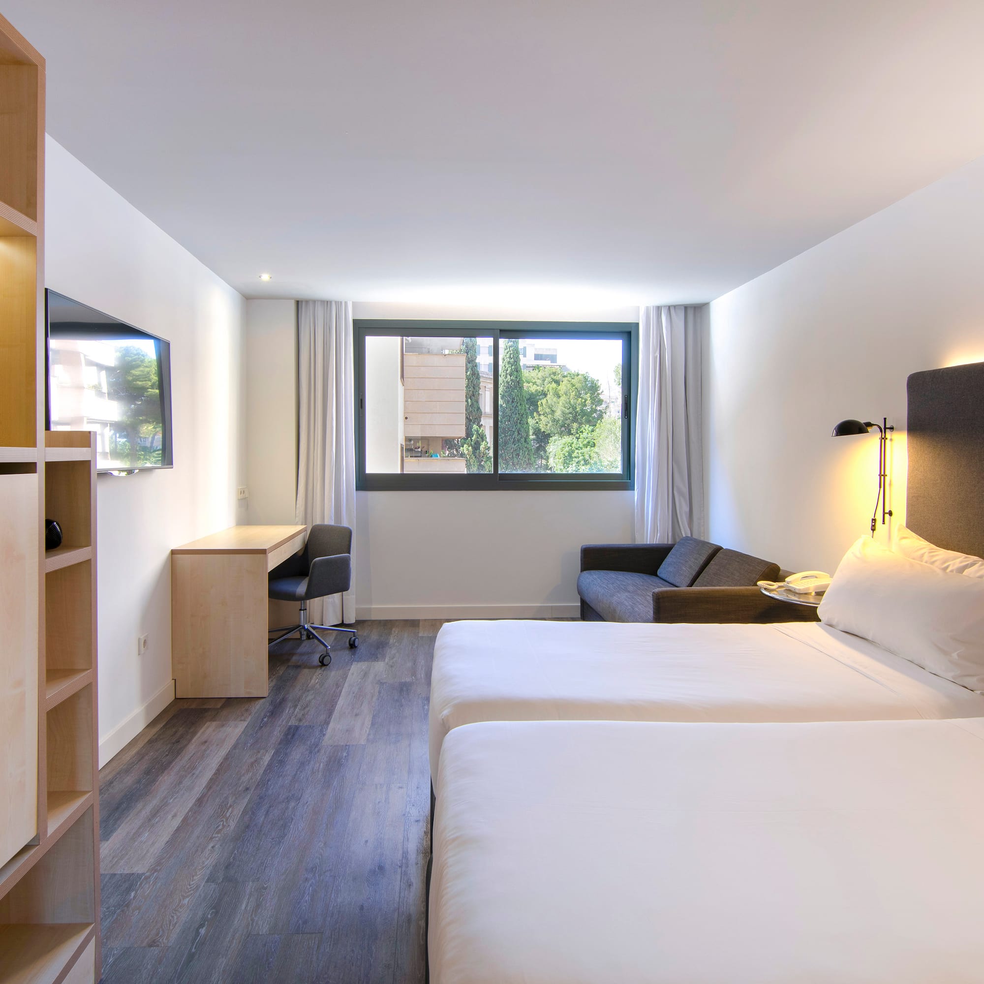 a room with two beds and a desk