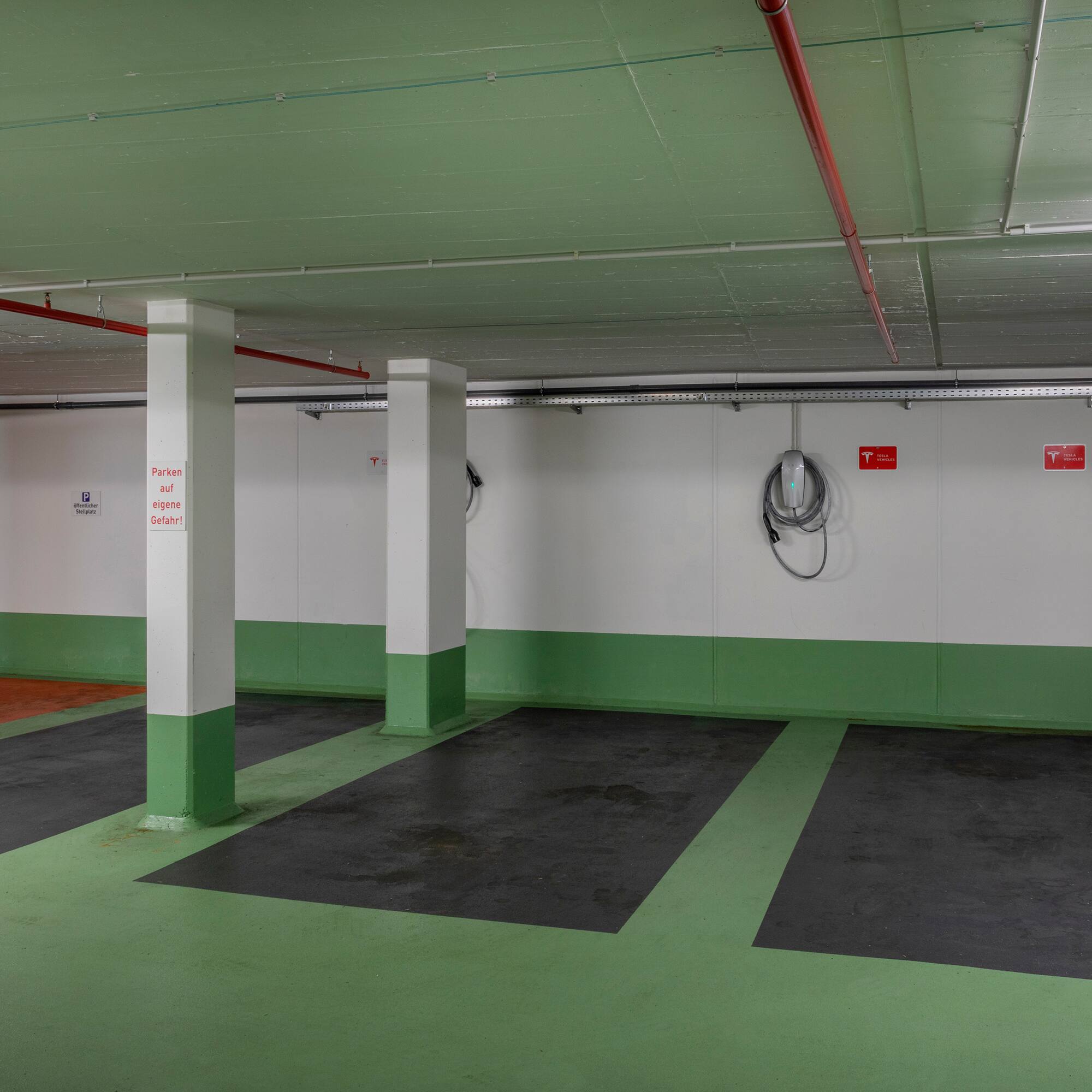 a green and white room with white pillars