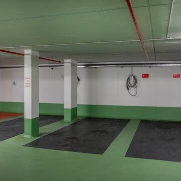 a green and white room with white pillars