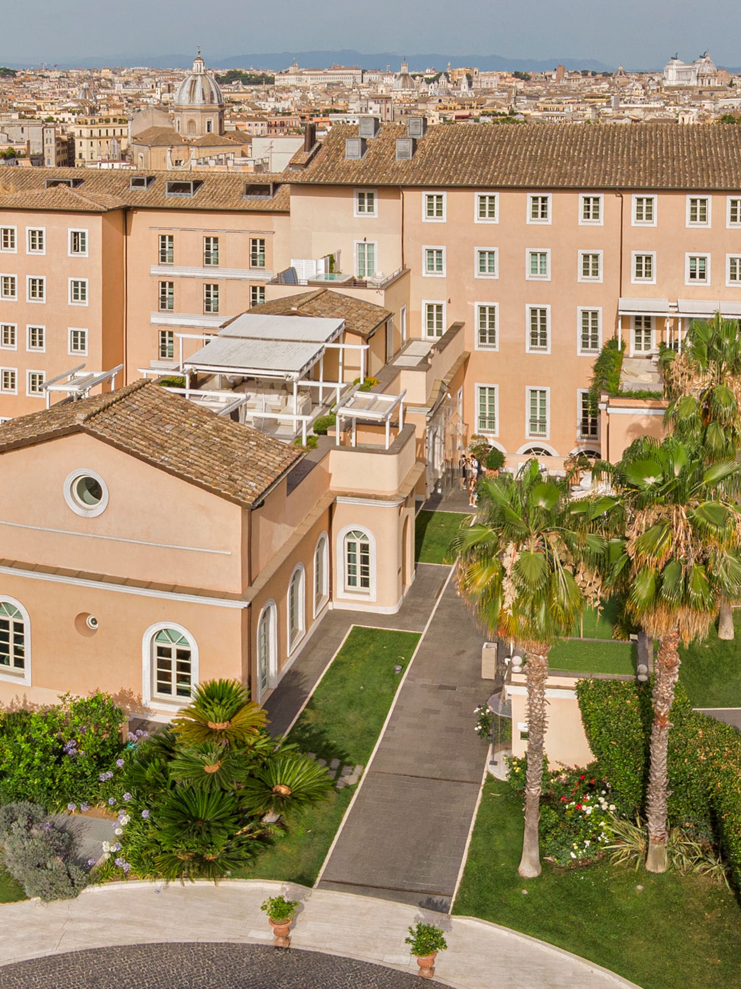 a large building with a courtyard and trees