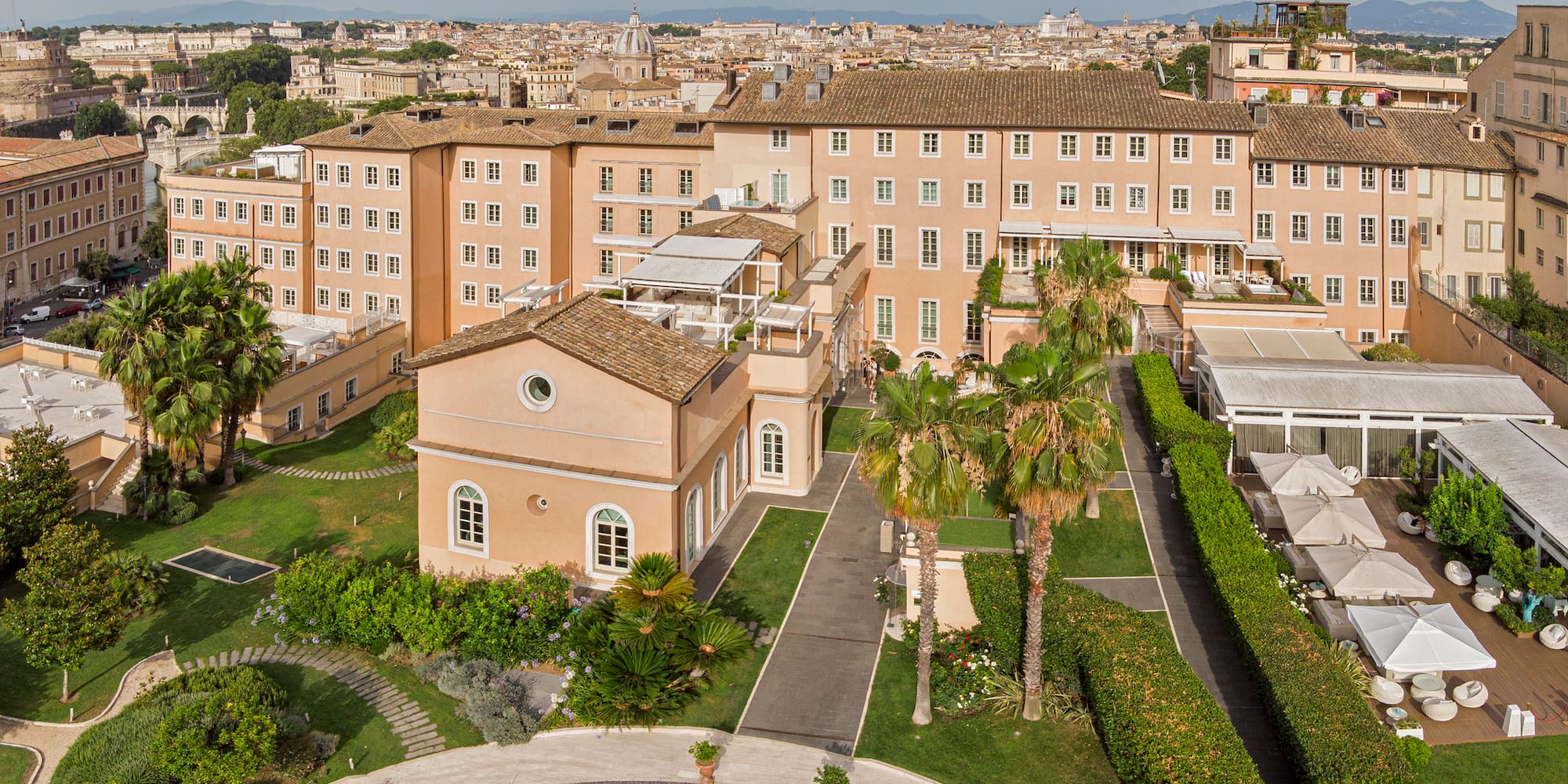 a large building with a courtyard and trees