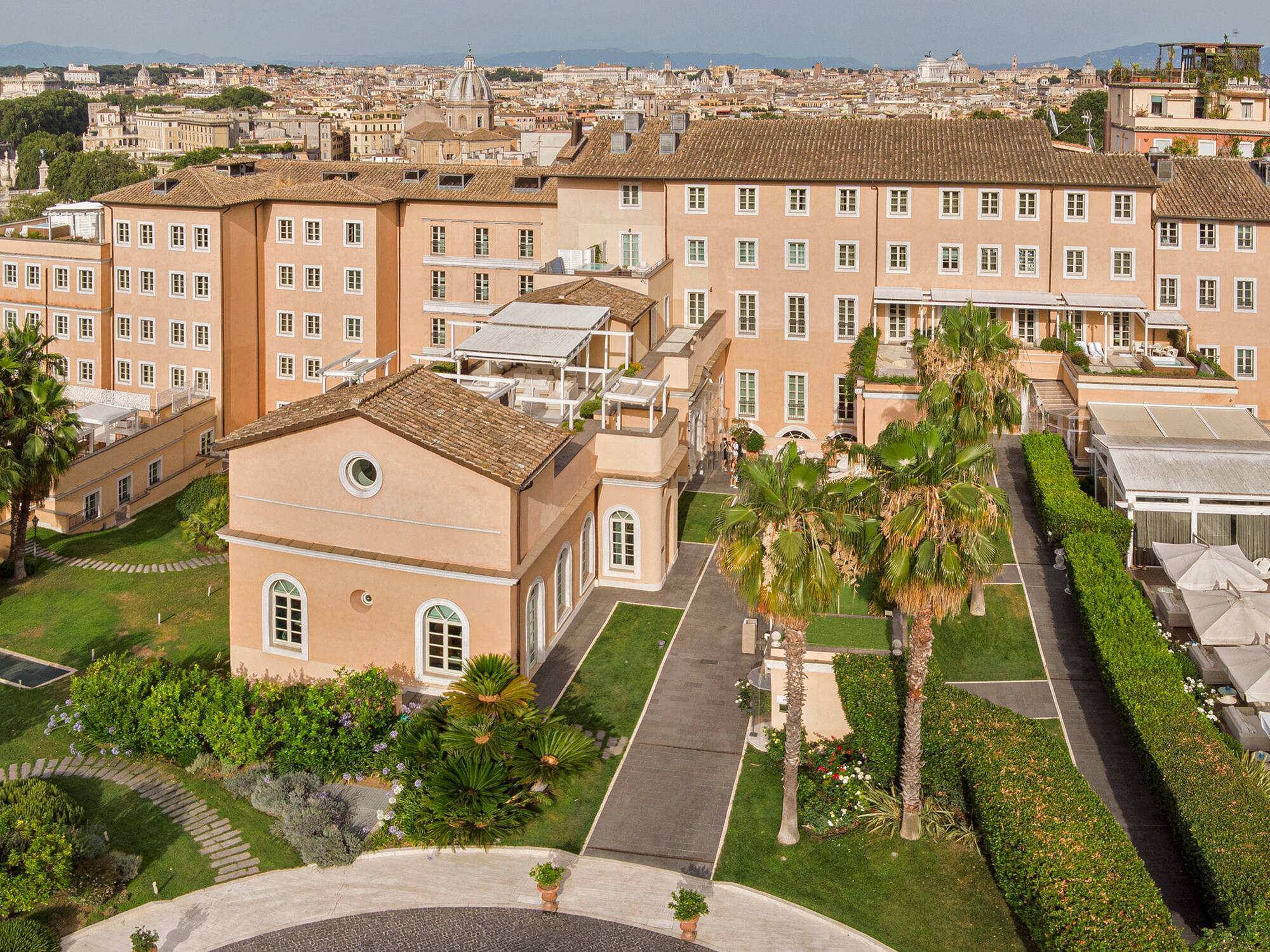 a large building with a courtyard and trees