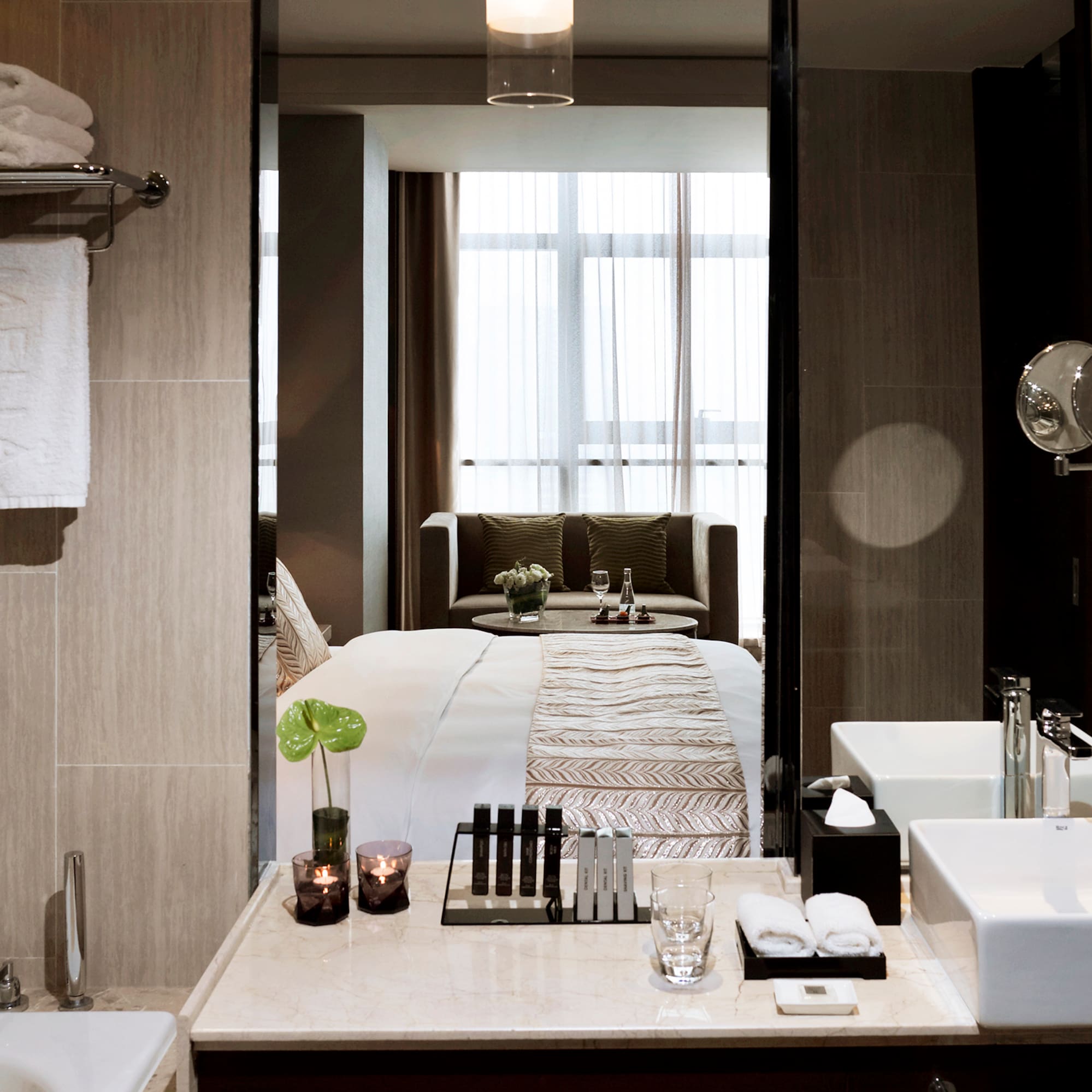 a bathroom with a mirror and a bed