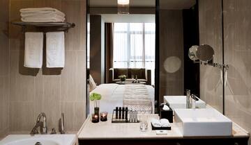 a bathroom with a mirror and a bed