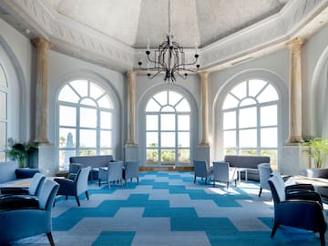 a room with blue and white checkered carpet and chairs