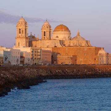 a building with domes and a body of water