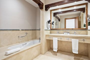 a bathroom with a bathtub and a mirror
