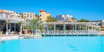 a pool with a white structure and palm trees