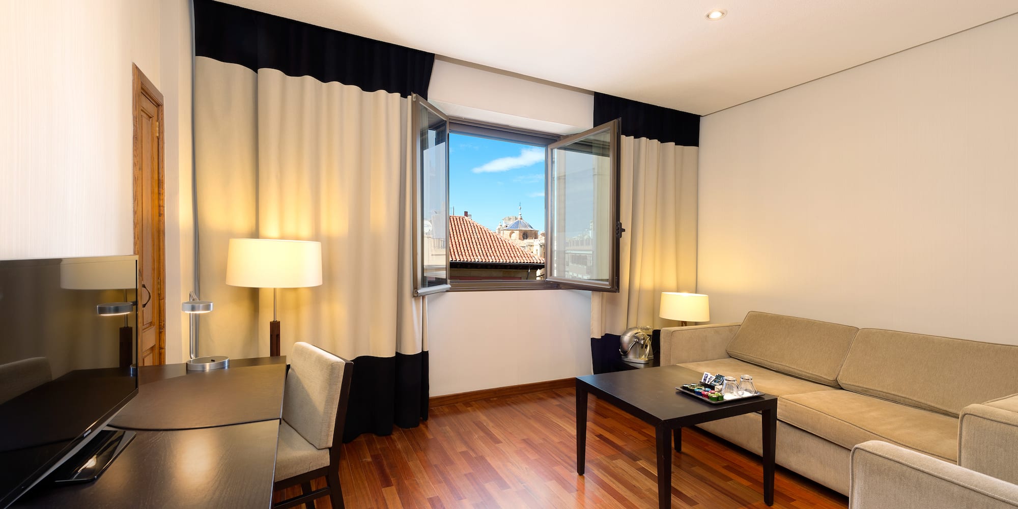 a room with a couch and table and chairs