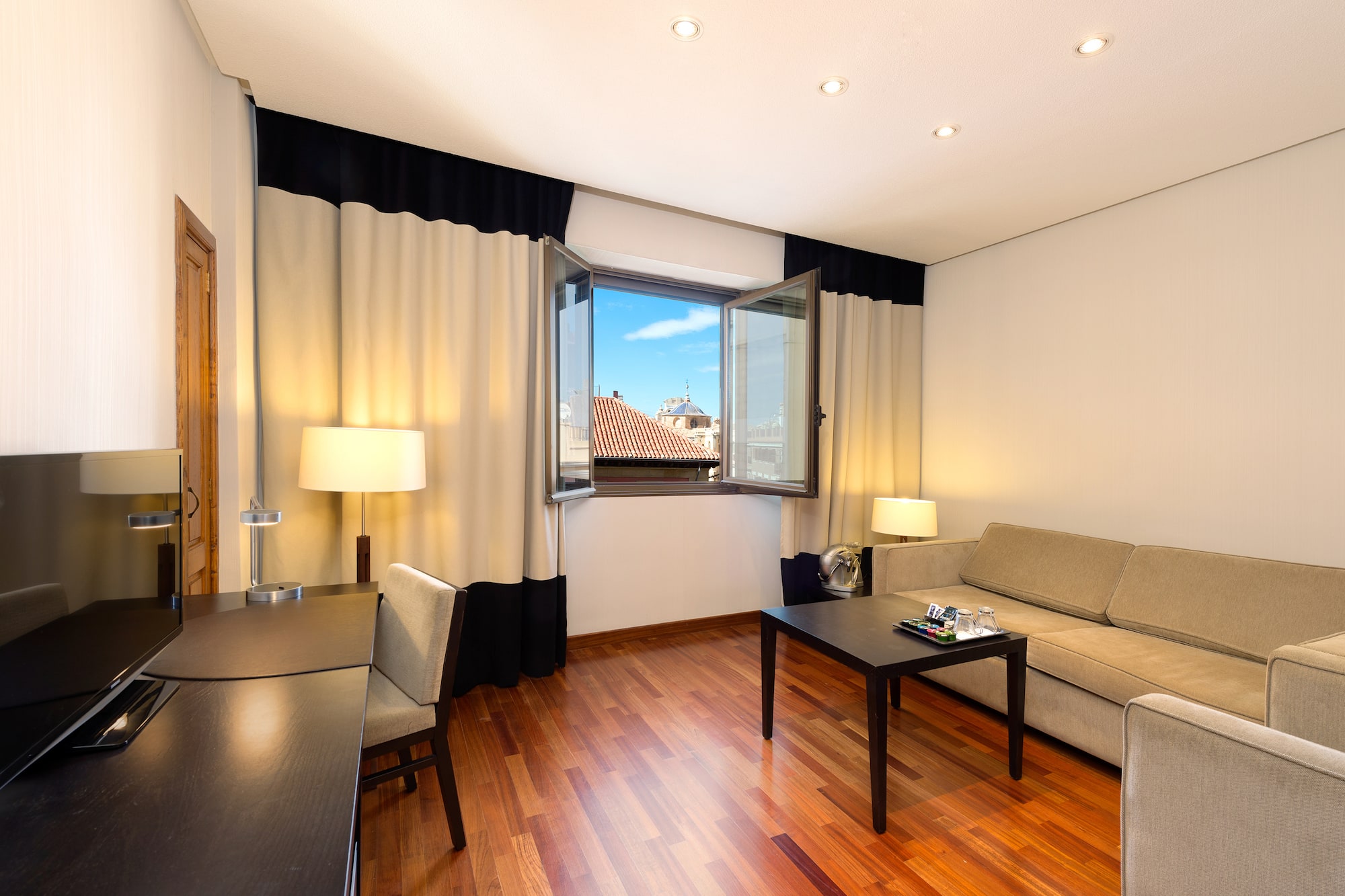 a room with a couch and table and chairs