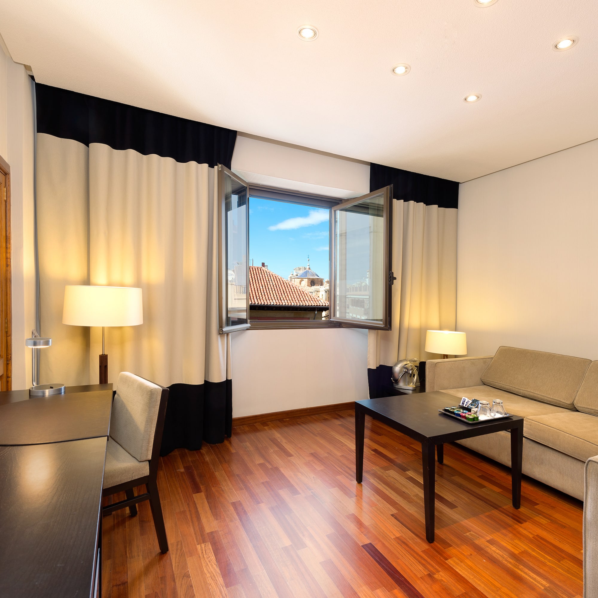 a room with a couch and table and chairs