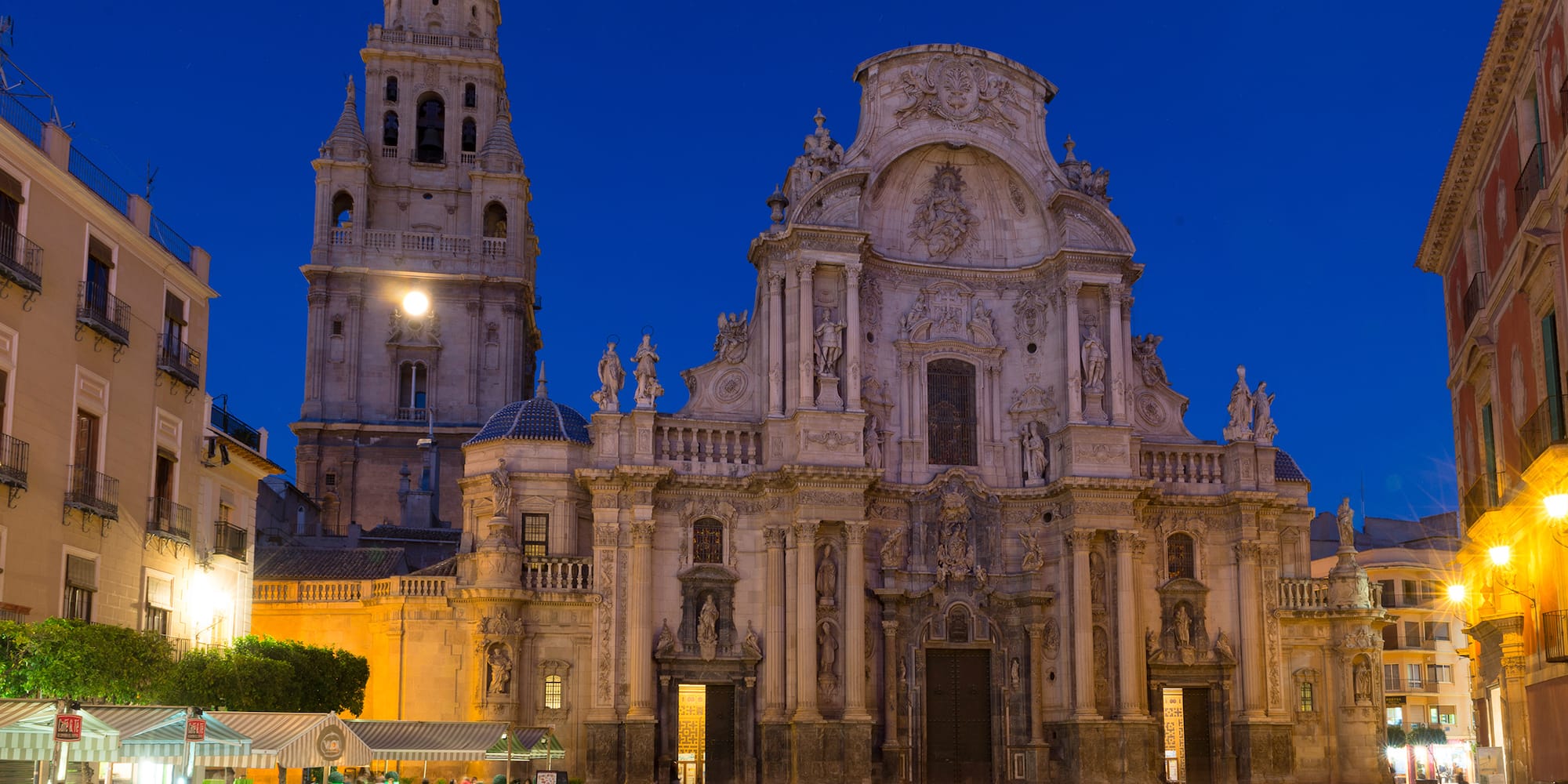 a large building with Cathedral of Murcia and people in front