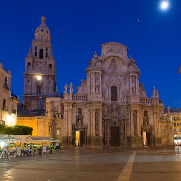 a large building with Cathedral of Murcia and people in front
