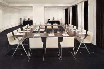 a room with a long table and chairs