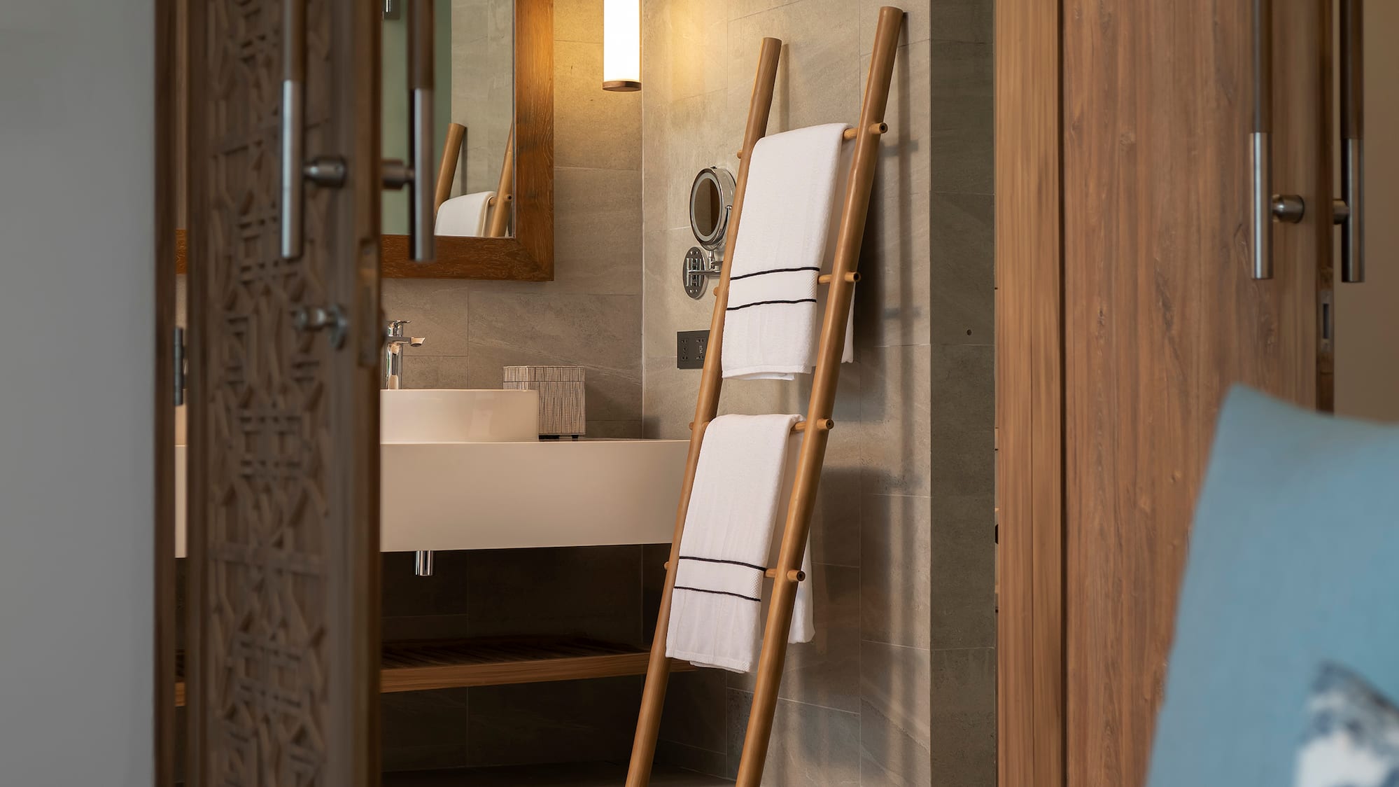 a bathroom with a mirror and a towel rack