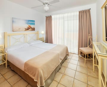 a bedroom with a bed and a fan