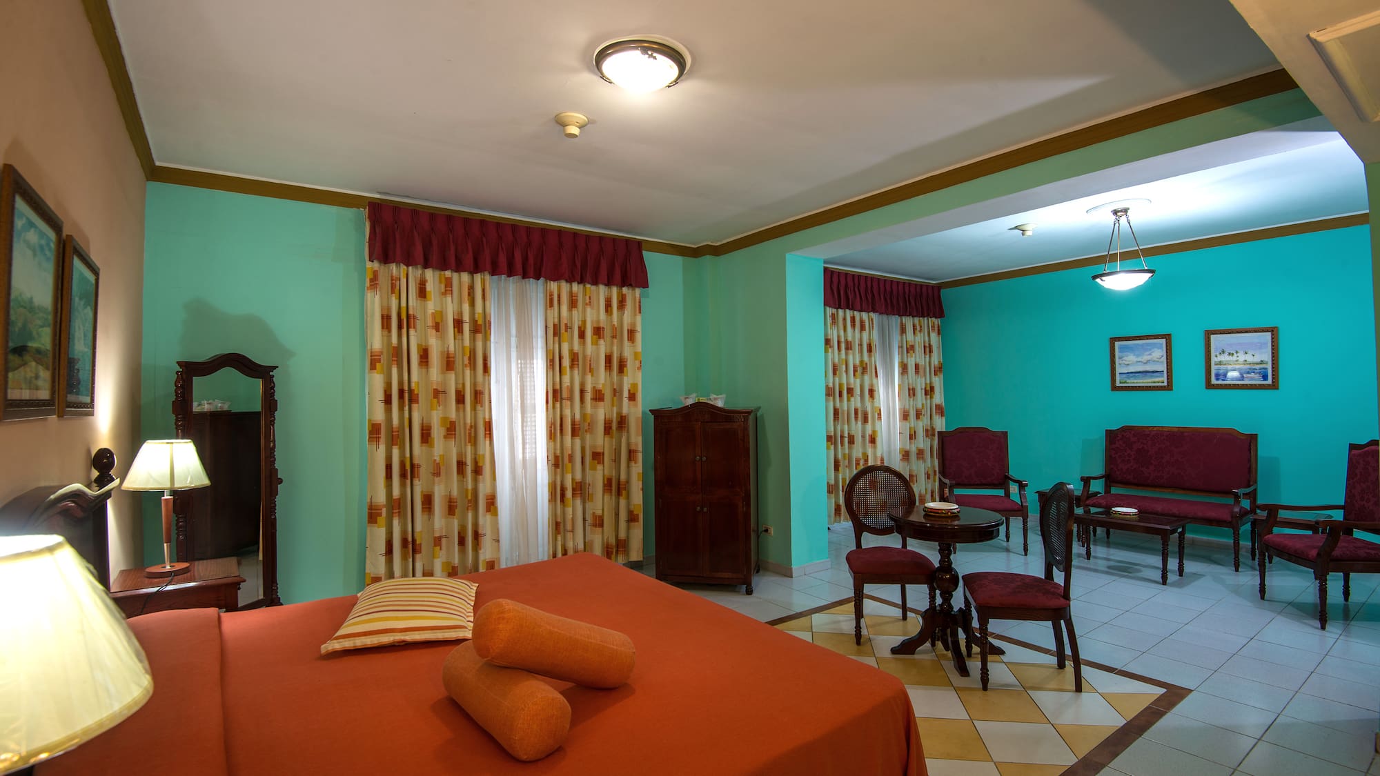 a room with a bed and chairs