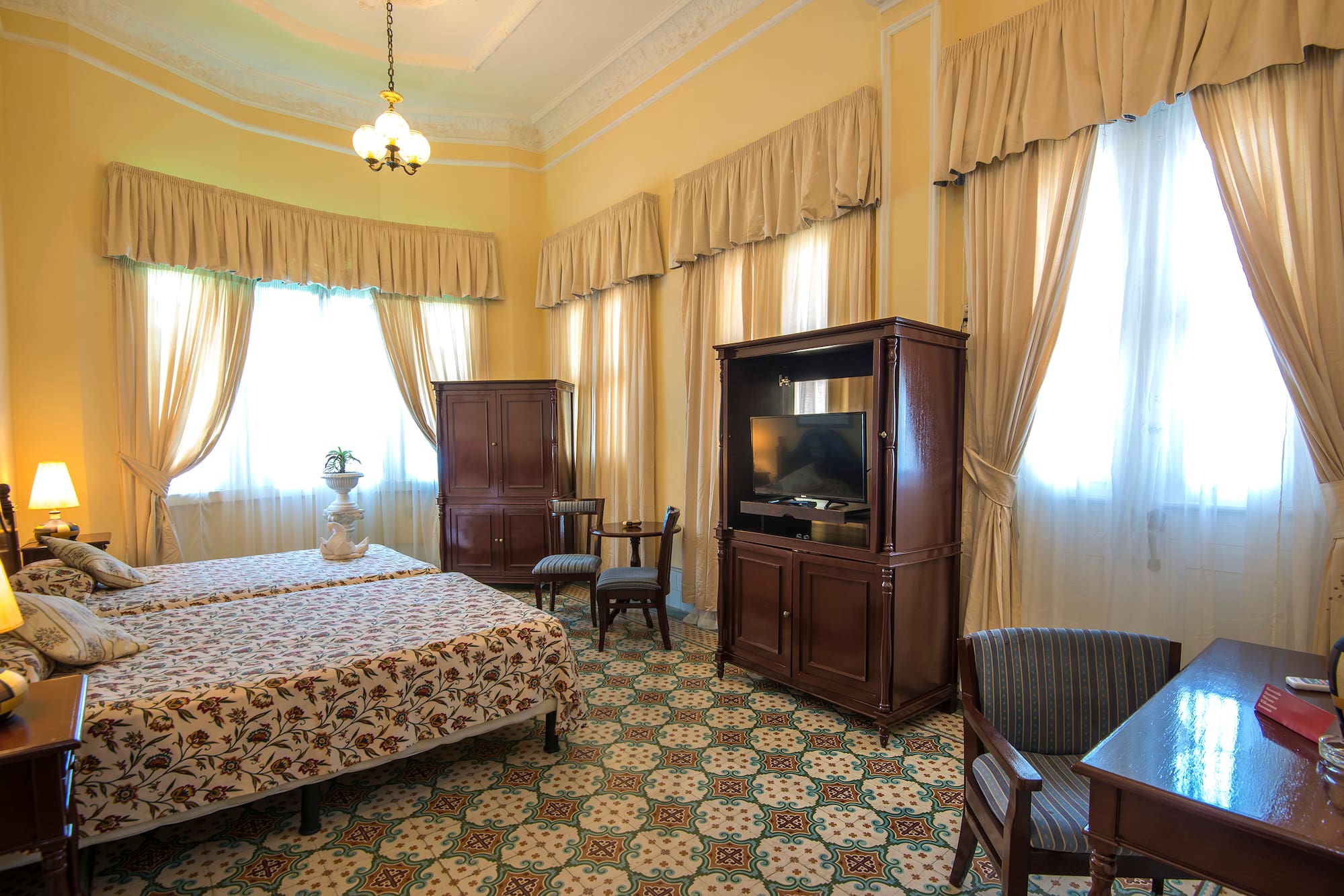 a room with a bed and a television