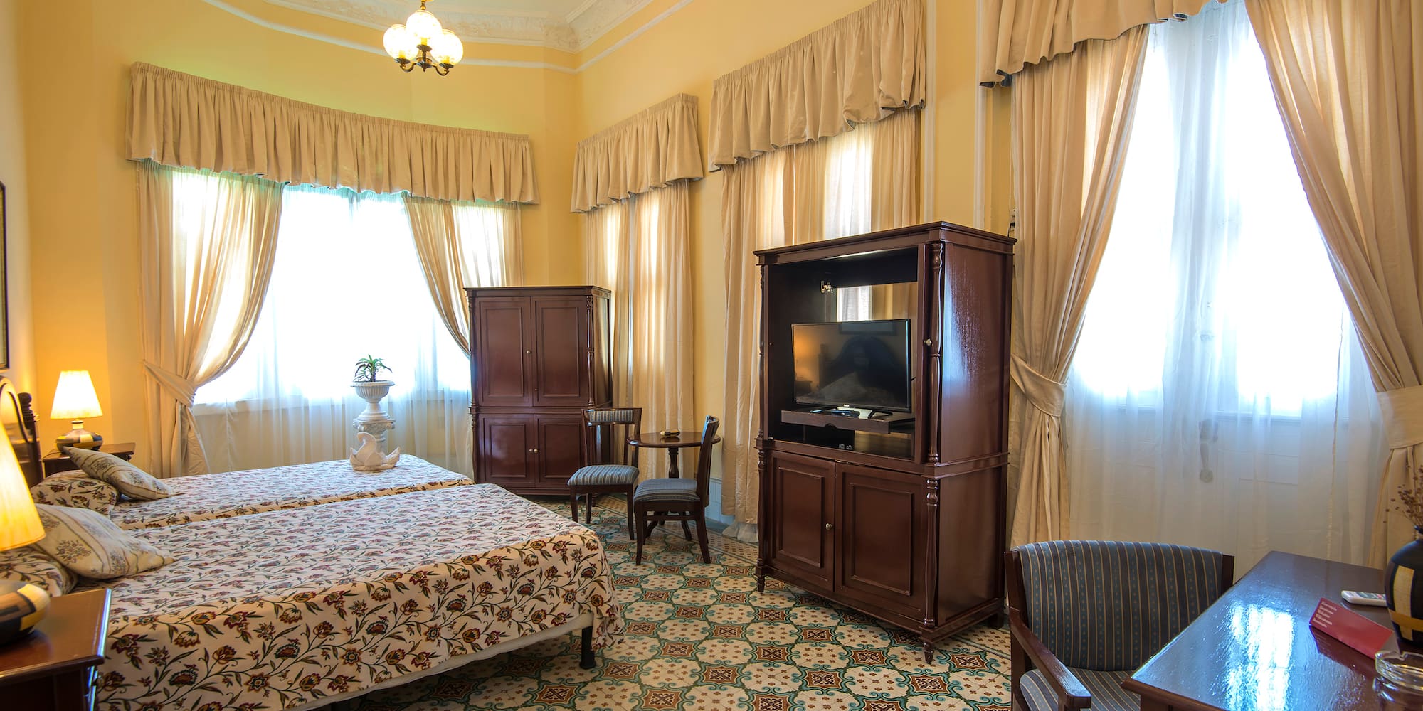 a room with a bed and a television