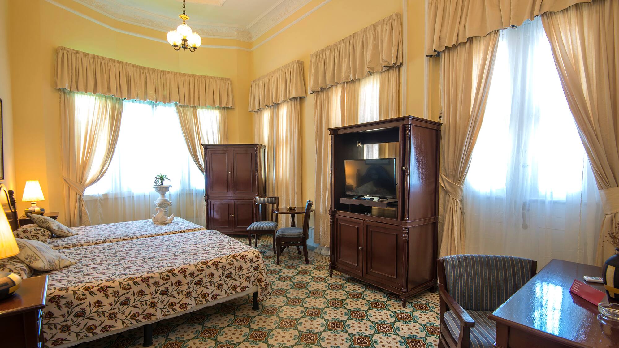 a room with a bed and a television