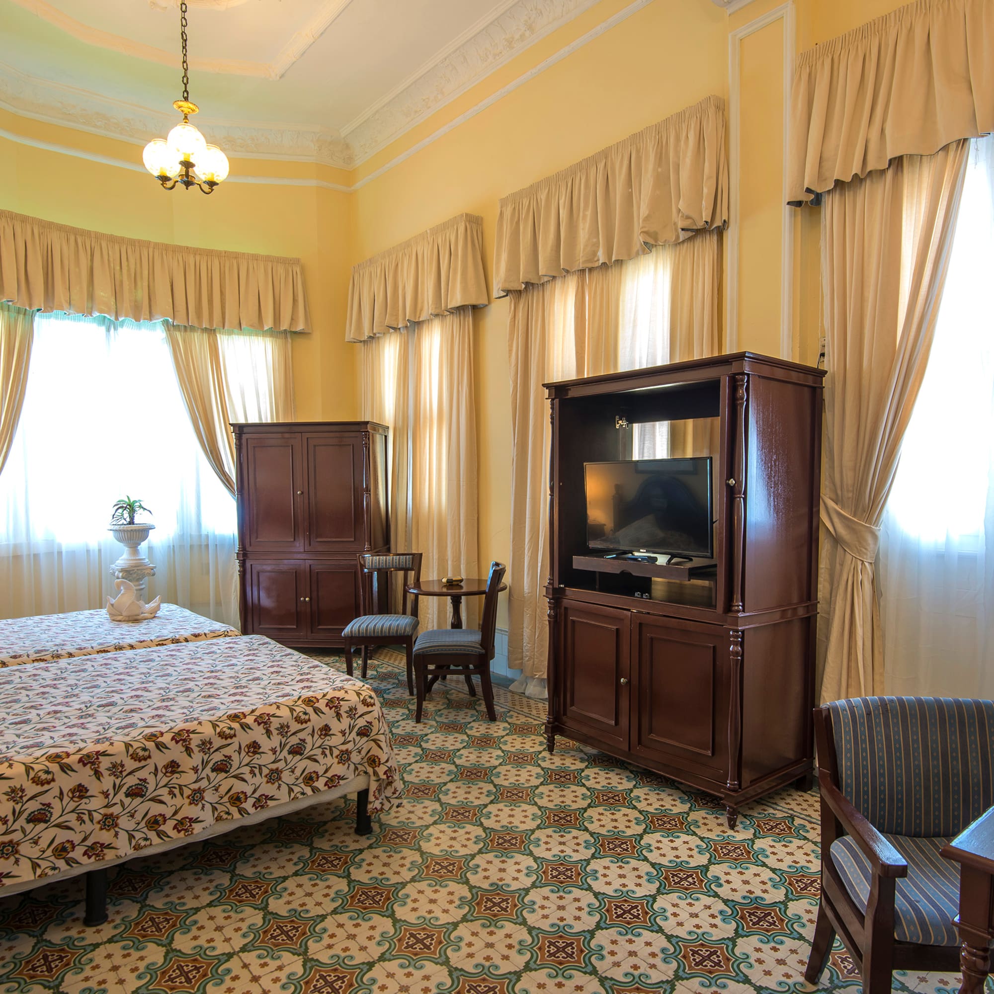 a room with a bed and a television