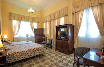 a room with a bed and a television