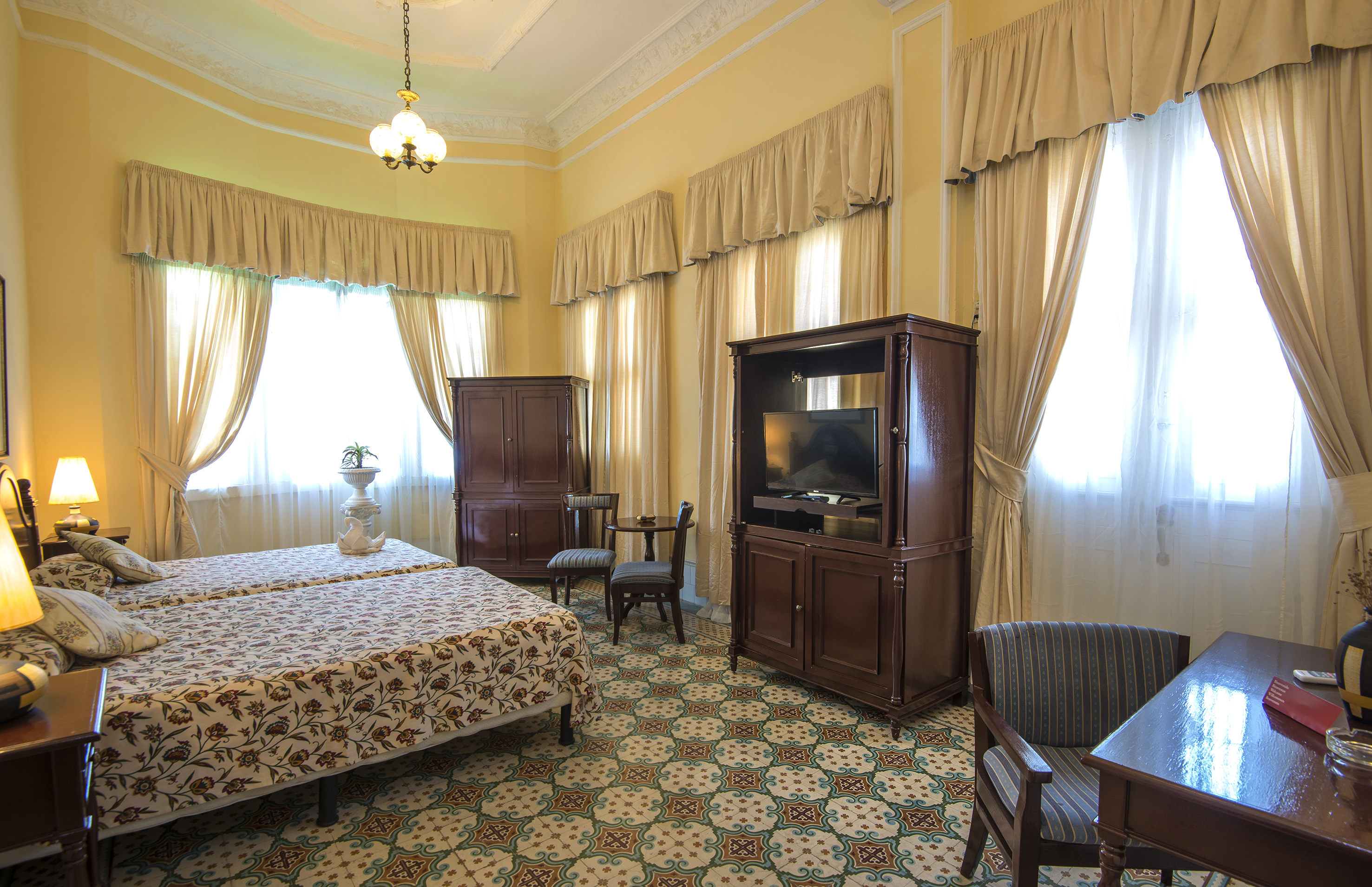 a room with a bed and a television