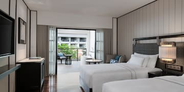 a room with two beds and a table