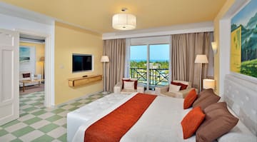 a room with a large bed and a television