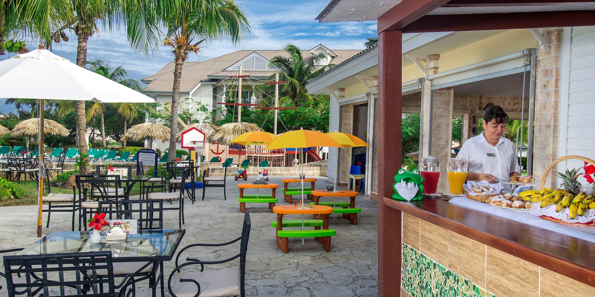 a woman sitting at a table outside of a restaurant