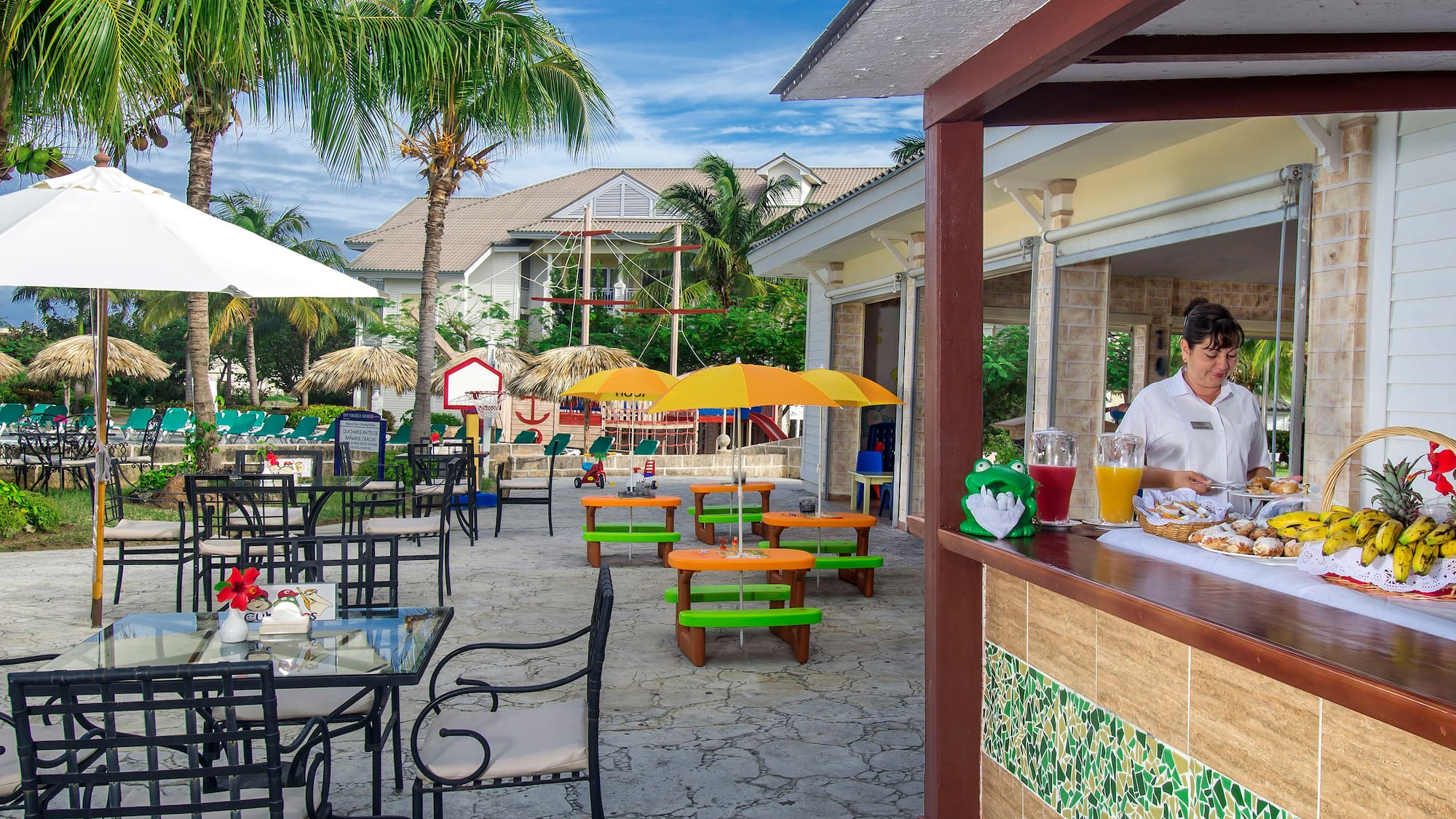 a woman sitting at a table outside of a restaurant
