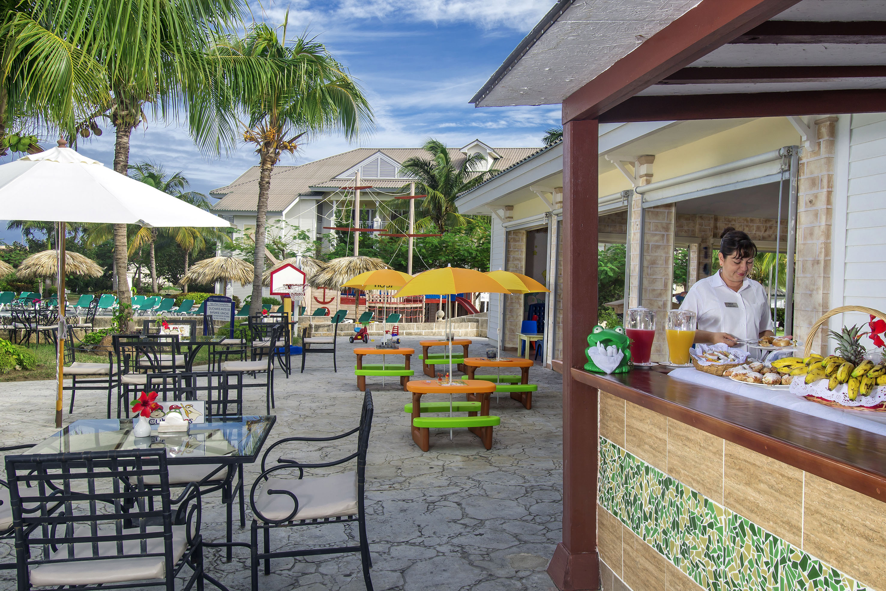 a woman sitting at a table outside of a restaurant