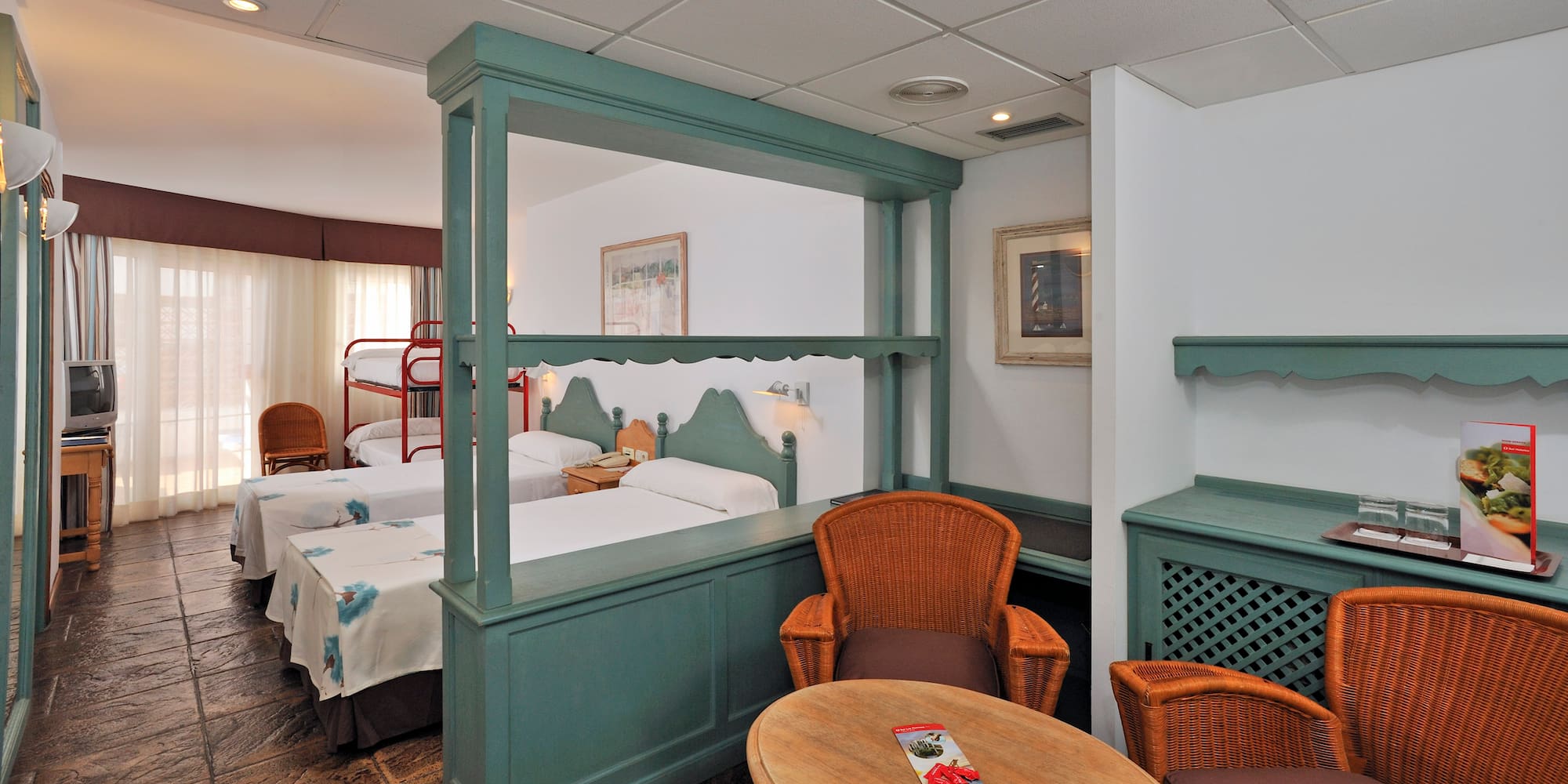 a room with two beds and a table